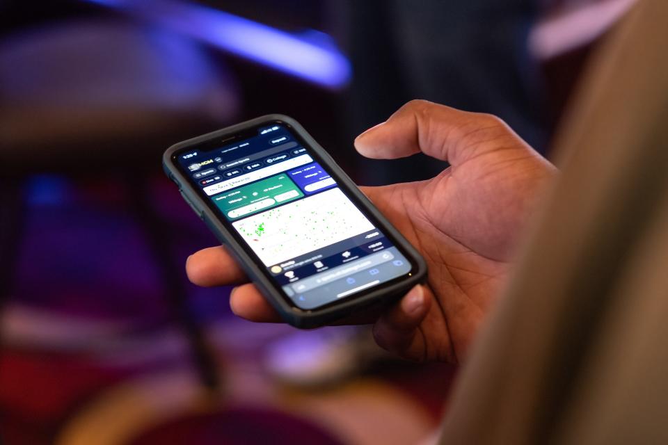 A guest signs up for the BetMGM smartphone app inside the MGM Northfield Park’s BetMGM Sportsbook & Lounge on the first day of legalized sports betting in Ohio, Sunday, Jan. 1, 2023.