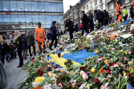 People leaving flowers on the steps on Sergels Torg following Friday's terror attack in central Stockholm, Sweden, Sunday, April 9, 2017. Noella Johansson/TT News Agency via REUTERS