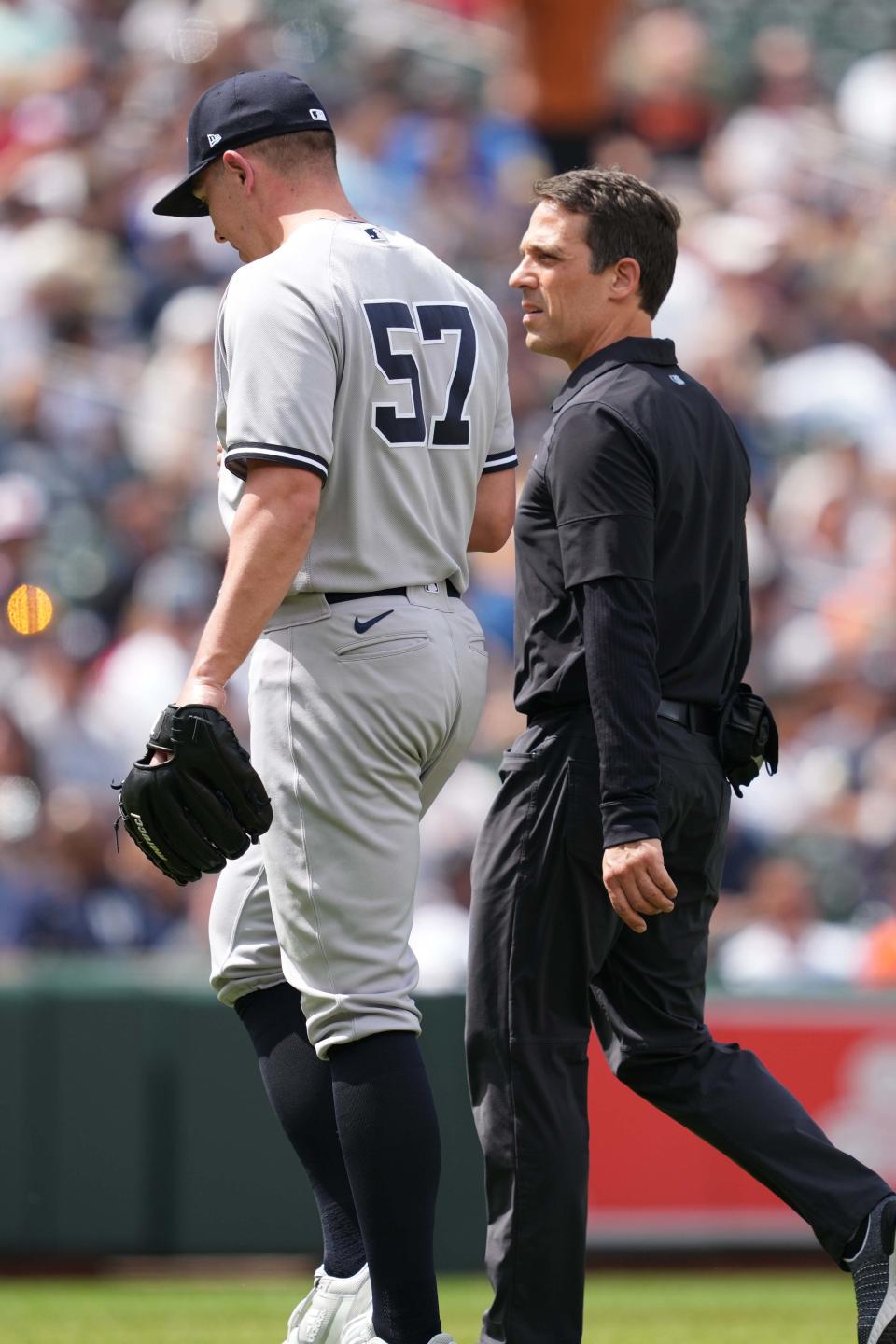 New York Yankees medical staff walks pitcher Chad Green (57) off the field in the sixth inning with an apparent injury against the Baltimore Orioles at Oriole Park at Camden Yards.