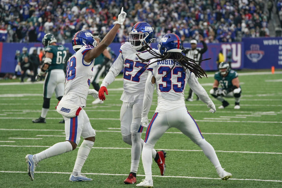 New York Giants' Aaron Robinson (33), right, celebrates with teammates after breaking up a play during the second half of an NFL football game against the Philadelphia Eagles, Sunday, Nov. 28, 2021, in East Rutherford, N.J. (AP Photo/Corey Sipkin)