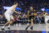 Utah Jazz forward Lauri Markkanen, left, defends against Golden State Warriors guard Jordan Poole, center, during the first half of an NBA basketball game in San Francisco, Friday, Nov. 25, 2022. (AP Photo/John Hefti)