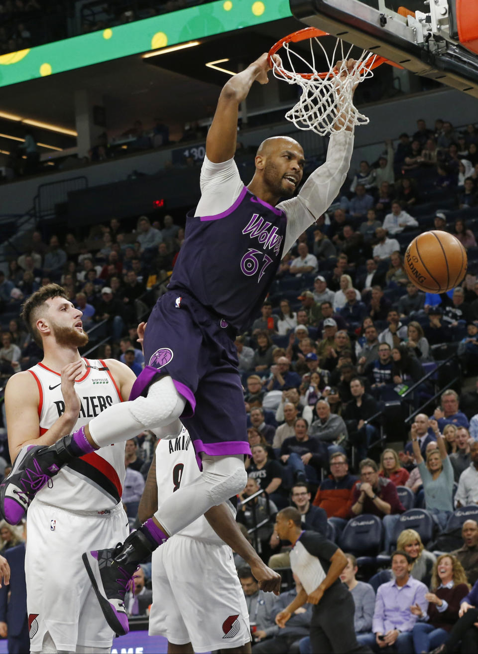 Minnesota Timberwolves' Taj Gibson, right, dunks as Portland Trail Blazers' Jusuf Nurkic watches during the second half of an NBA basketball game Friday, Nov. 16, 2018, in Minneapolis. The Timberwolves won 112-96. (AP Photo/Jim Mone)