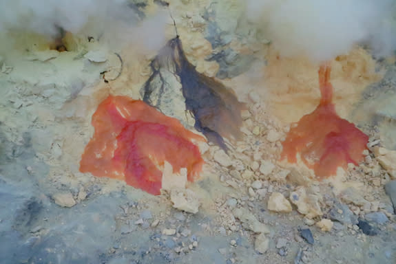 Molten elemental sulfur (orange) and solid sulfur deposits (yellow) at Ijen Crater.