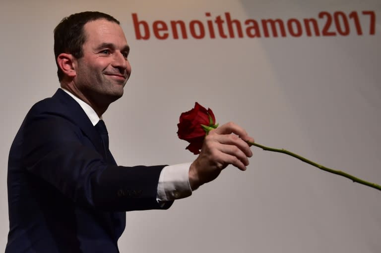 Benoit Hamon holds a rose following the first results of the primary's second round on January 29, 2017