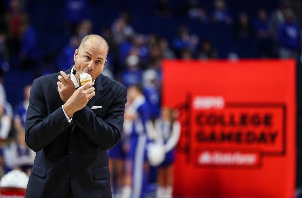 ESPN analyst Jay Bilas enjoys an ice cream given to him by British cheerleaders at a "College Game Day" segment before the 2019 Kentucky-Kansas game.