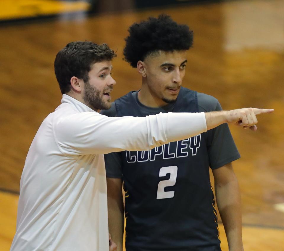 Copley boys basketball coach Nate Moran, left, speaks with Christian Hood during the second half of a game Jan. 27 at Cuyahoga Falls.