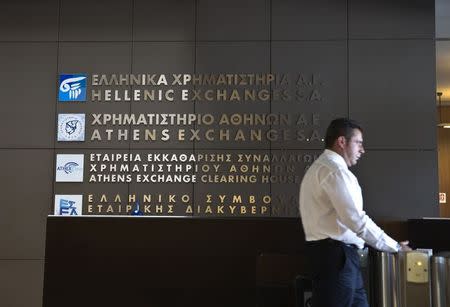 A security officer stands at the entrance to the Athens' stock exchange , Greece July 27, 2015. REUTERS/Ronen Zvulun