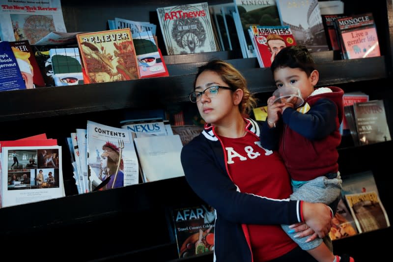 Christina Morales, a line cook of two years at Farley’s East cafe that closed due to the financial crisis caused by the coronavirus disease (COVID-19), holds her son Pablo, 2, at the cafe in Oakland