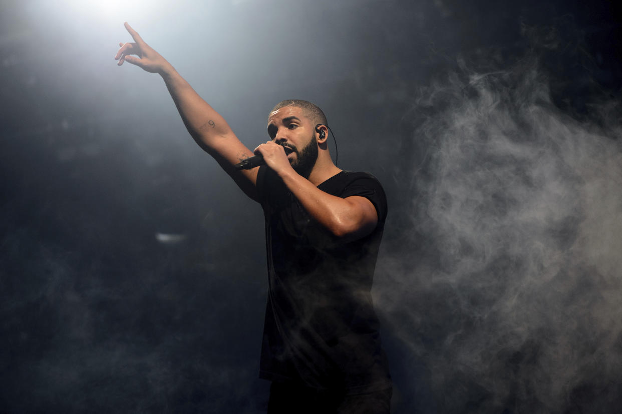 FILE - In this June 27, 2015 file photo, Canadian singer Drake performs on the main stage at Wireless festival in Finsbury Park, London.  Drake has landed his 208th song on the Billboard Hot 100 chart, setting a new record for most songs on the music chart. The rapper's latest track, “Oprah's Bank Account