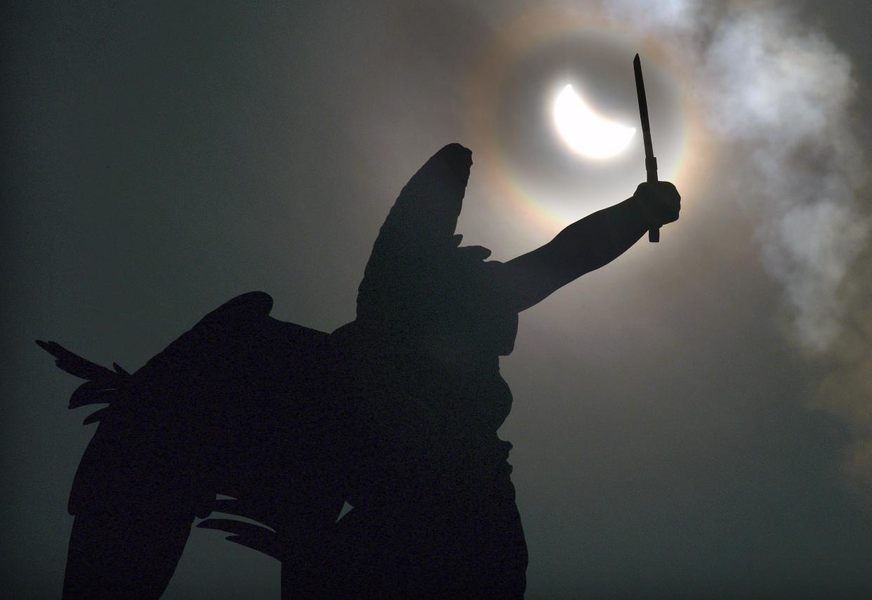 The angel at the top of the Soldiers' and Sailors' Memorial on Worcester Common raises her sword to the partial eclipse.