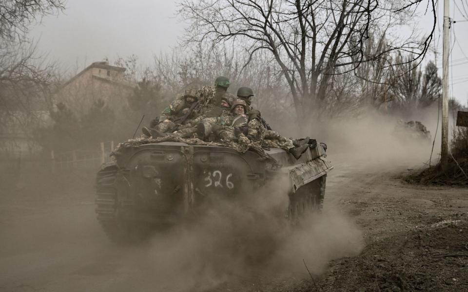 Ukrainian servicemen head toward Bakhmut in a BMP infantry fighting vehicle - ARIS MESSINIS/AFP