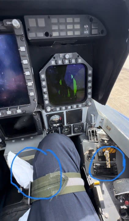 Under the thigh strap, passengers are provided with motion sickness bags. Also, there are additional vents on each side of the compartment. The black and yellow switch arms the pyrotechnics for the ejection seat.