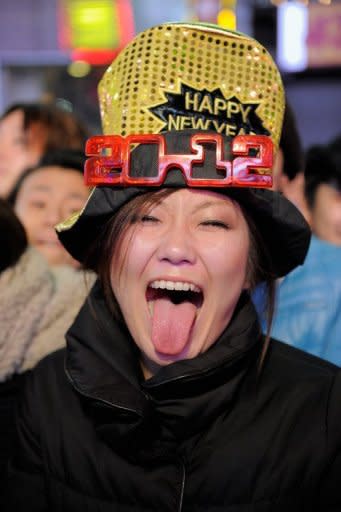 A reveler makes a face as she joins thousands gathered in New York's Times Square to celebrate the ball drop at the annual New Years Eve celebration