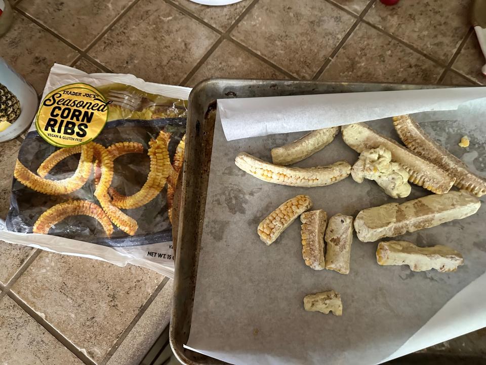 corn ribs bag from trader joe's on counter next to pieces of corn on parchment paper on baking sheet