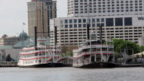 The Natchez, right, and another tourist riverboat sit at the dock because of COVID-19 precautions, Friday, April 3, 2020 in New Orleans. A few people were on the Natchez, which played a 15-minute medley of hymn and gospel tunes Friday as a tribute to the late jazz pianist and educator Ellis Marsalis, who died Wednesday of pneumonia brought on by the novel coronavirus. (AP Photo/Janet McConnaughey)