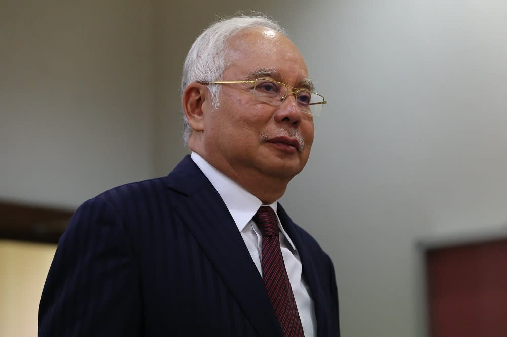 Former Prime Minister Datuk Seri Najib Razak walks out of the courtroom for a break at the Kuala Lumpur High Court Complex October 14, 2019. — Picture by Yusof Mat Isa