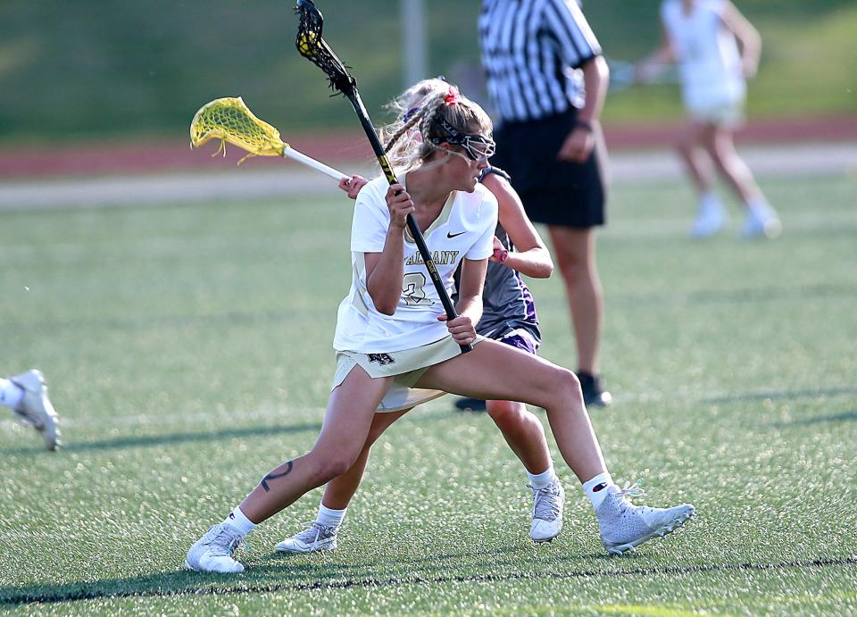 New Albany's Madison Paz works against Jackson's Annise Berkeley during their lacrosse match Tuesday, May 31, 2022 at Ashland University. TOM E. PUSKAR/TIMES-GAZETTE.COM