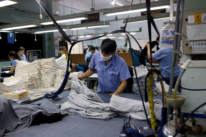 FILE PHOTO: A man works at a garment assembly line of Thanh Cong textile, garment, investment and trading company in Ho Chi Minh city