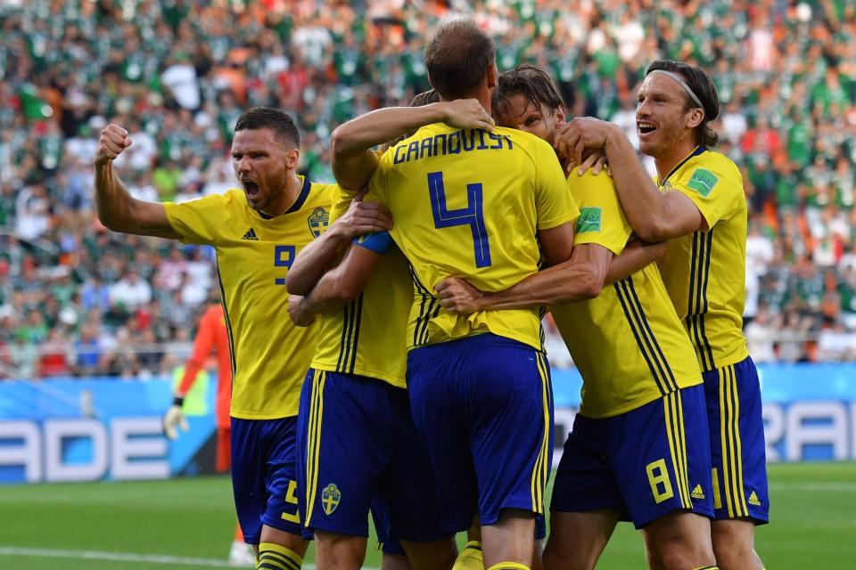 Sweden’s defender Andreas Granqvist (4) celebrates with teammates after scoring a penalty during the Russia 2018 World Cup Group F football match between Mexico and Sweden at the Ekaterinburg Arena in Ekaterinburg on June 27, 2018. (Getty Images)