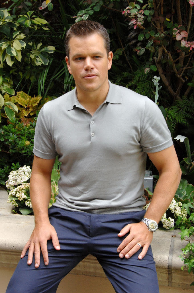 Matt sitting on a bench at the bourne ultimatum presser