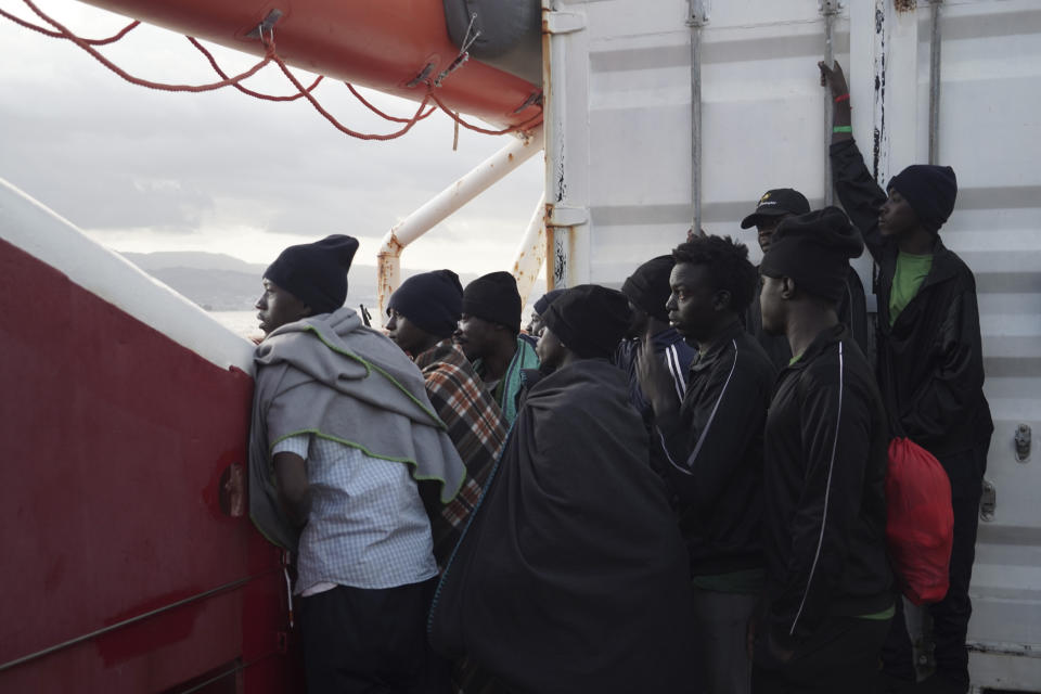 Men wait to disembark from the Ocean Viking ship as it reaches the port of Messina, Italy, Tuesday, Sept. 24, 2019. The humanitarian ship has docked in Italy to disembark 182 men, women and children rescued in the Mediterranean Sea after fleeing Libya. (AP Photo/Renata Brito)