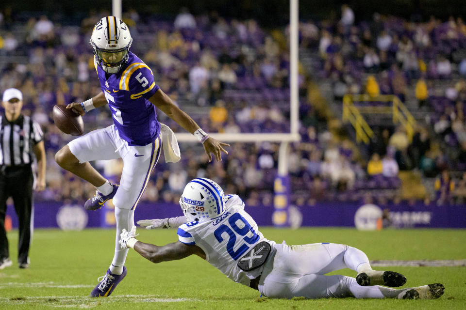 DFILE - LSU quarterback Jayden Daniels (5) breaks away from Georgia State safety TyGee Leach (29) during the second half of an NCAA college football game in Baton Rouge, La., Saturday, Nov. 18, 2023. Daniels was selected as The Associated Press college football player of the year, Thursday, Dec. 7, 2023, the school's second winner in the past five seasons. (AP Photo/Matthew Hinton, File)