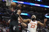 Miami Heat center Bam Adebayo, left gets a rebound in front of New York Knicks center Mitchell Robinson (23) during the first half of an NBA basketball game, Tuesday, April 2, 2024, in Miami. (AP Photo/Lynne Sladky)