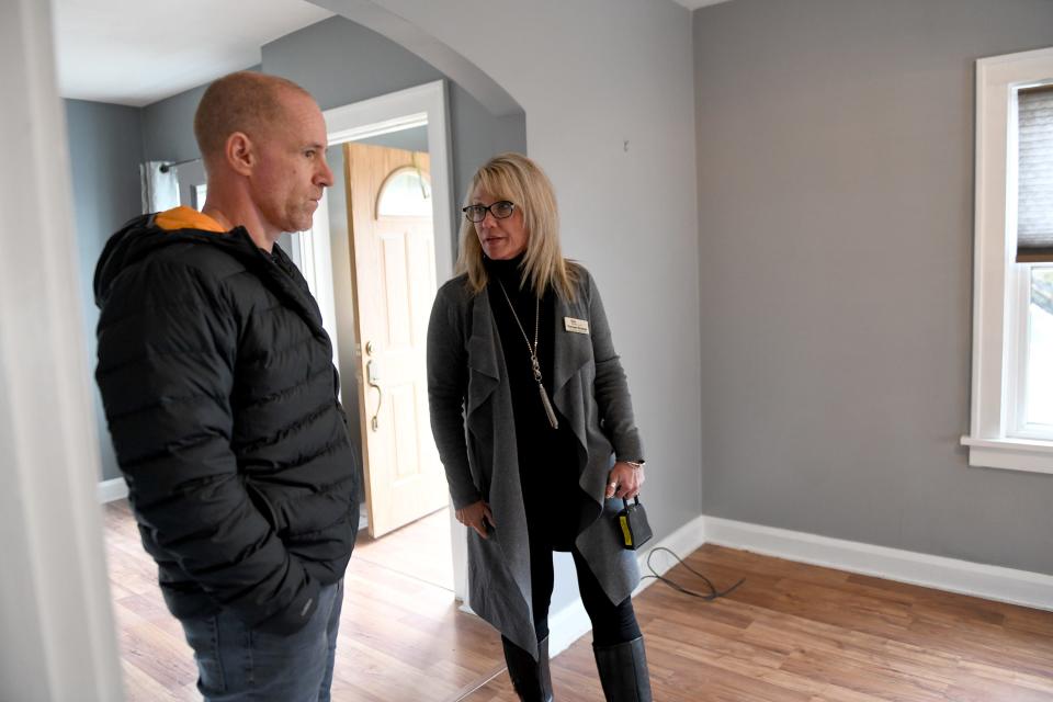 John Hunt does a final walk through last week of his new North Canton home with Realtor Tiffany Pepper of Keller Williams Legacy Group. Real estate experts say the hot housing market is expected to cool off this year.