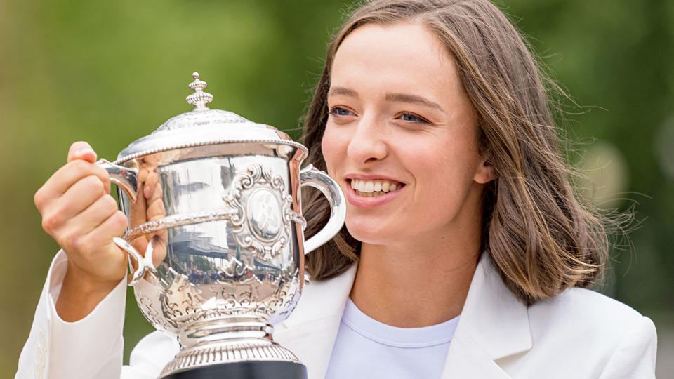 Pictured here, French Open champion Iga Swiatek poses with the trophy she won at Roland Garros.