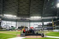 Wisconsin Gov. Tony Evers signs Assembly Bill 438 and Assembly Bill 439 at American Family Field Tuesday, Dec. 5, 2023, in Milwaukee. The bills use public funds to help the Milwaukee Brewers repair their stadium over the next three decades. (AP Photo/Morry Gash)