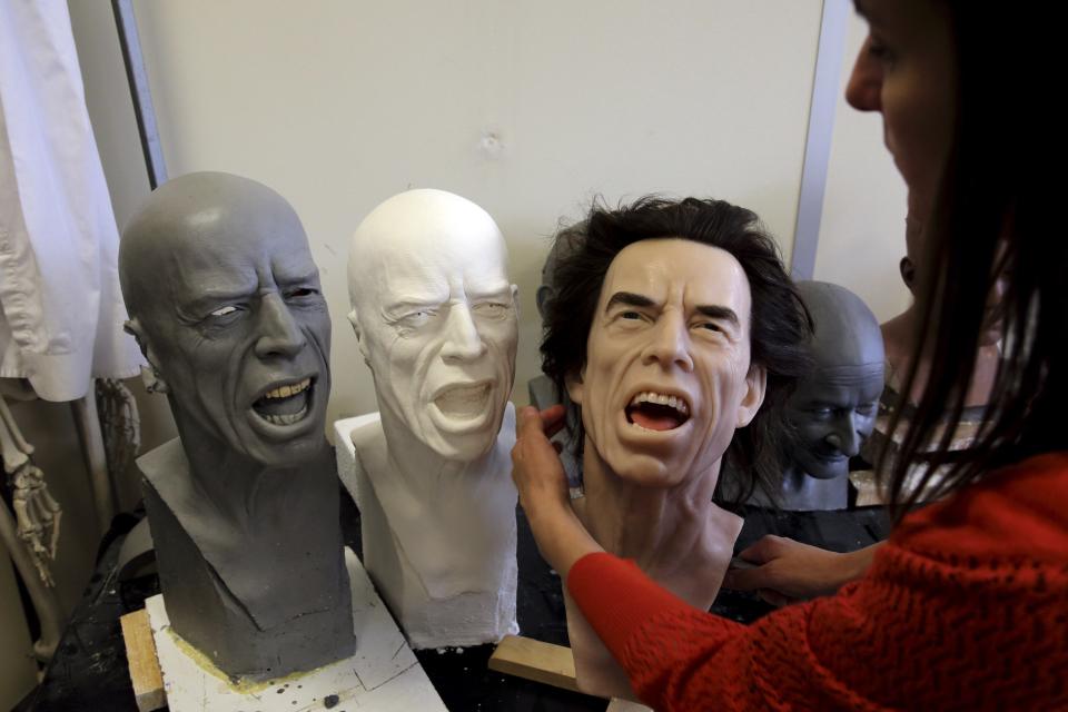 Helene Jonca, one of the painters of the Paris Grevin wax sculpture museum works on the head of Rolling Stones lead singer Mick Jagger in their workshop in Paris