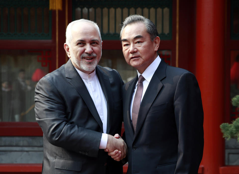 Iranian Foreign Minister Mohammad Javad Zarif, left, and his Chinese counterpart Wang Yi shake hands during their meeting at the Diaoyutai State Guesthouse in Beijing Tuesday, Feb. 19, 2019. (How Hwee Young/Pool Photo via AP)