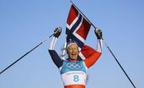 Cross-Country Skiing - Pyeongchang 2018 Winter Olympics - Women's 30km Mass Start Classic - Alpensia Cross-Country Skiing Centre - Pyeongchang, South Korea - February 25, 2018 - Marit Bjoergen of Norway celebrates winning the race holding a Norway flag. REUTERS/Carlos Barria