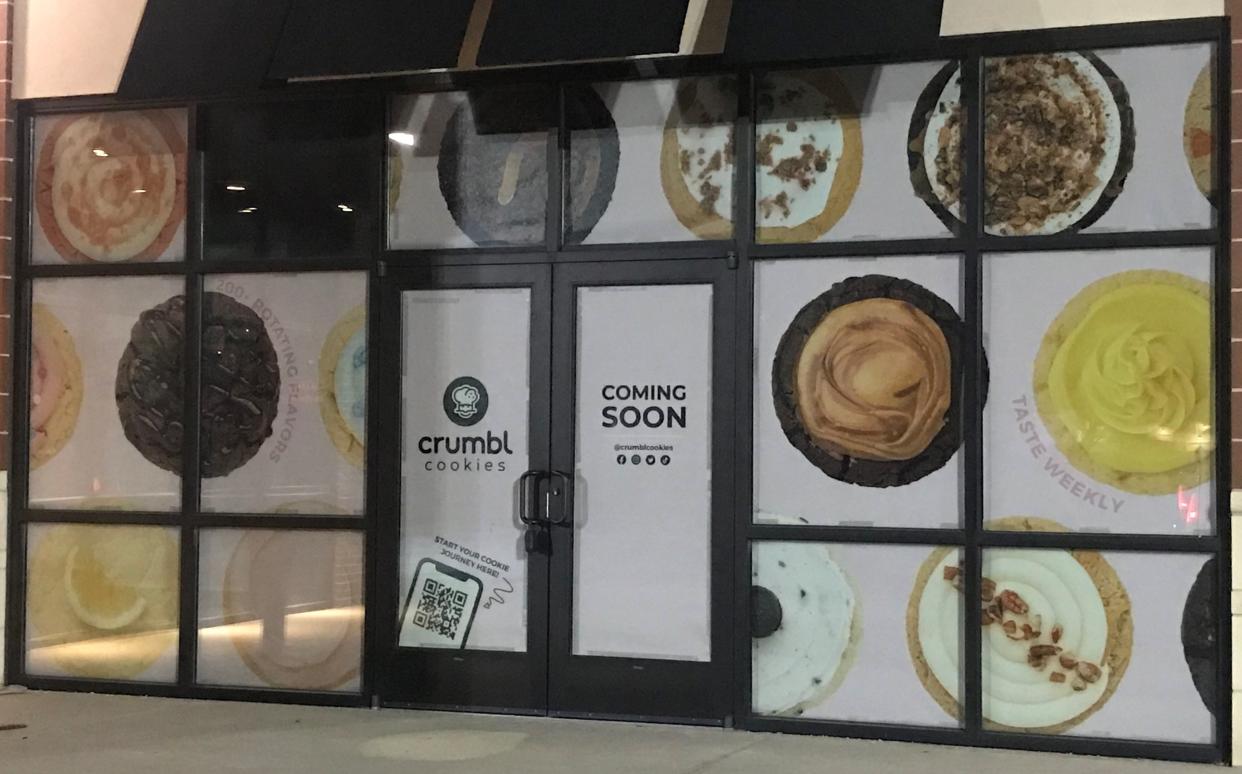 Signs indicate that a Crumbl Cookies bakery will be opening soon in the 6100 block of East State Street in Rockford.