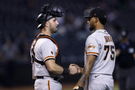 San Francisco Giants catcher Joey Bart, left, greets relief pitcher Camilo Doval after the team's 6-2 win in a baseball game against the Arizona Diamondbacks on Thursday, May 11, 2023, in Phoenix. (AP Photo/Chris Coduto)