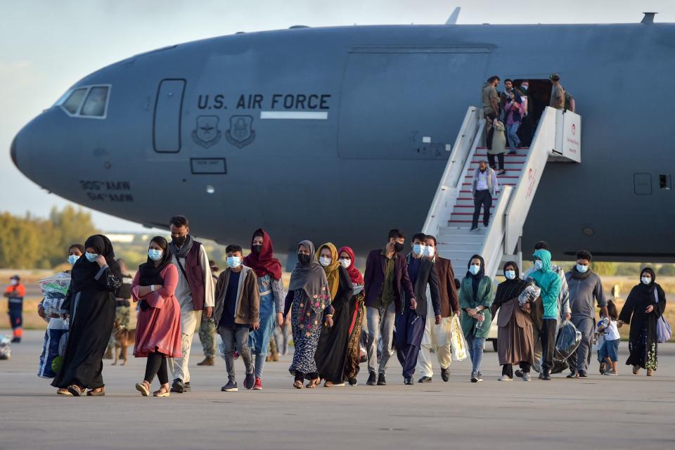 Refugees disembark from a US air force aircraft after an evacuation flight from Kabul at the Rota naval base in Rota, southern Spain, on August 31, 2021. (Cristina Quicler/AFP via Getty Images)