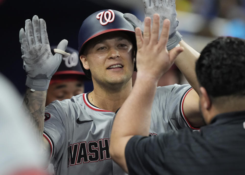 Washington Nationals' Nick Senzel (13) is congratulated un the dugout after hitting a home run during the seventh inning of a baseball game against the Miami Marlins, Saturday, April 27, 2024, in Miami. (AP Photo/Marta Lavandier)