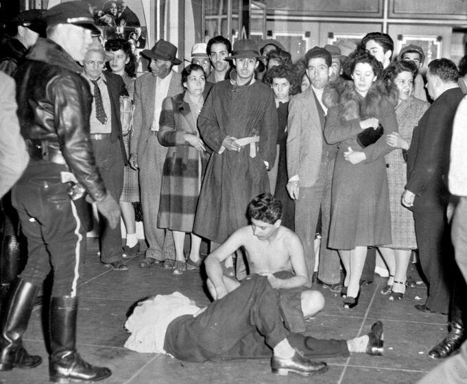 These youths, one stripped of all his clothes and the other badly beaten, fell victim to raging bands of servicemen who scoured the streets in Los Angeles, June 20, 1943, looking for and beating zoot suited youths. The servicemen blame the zoot suited youths for numerous unprovoked assaults on their colleagues. (AP Photo)