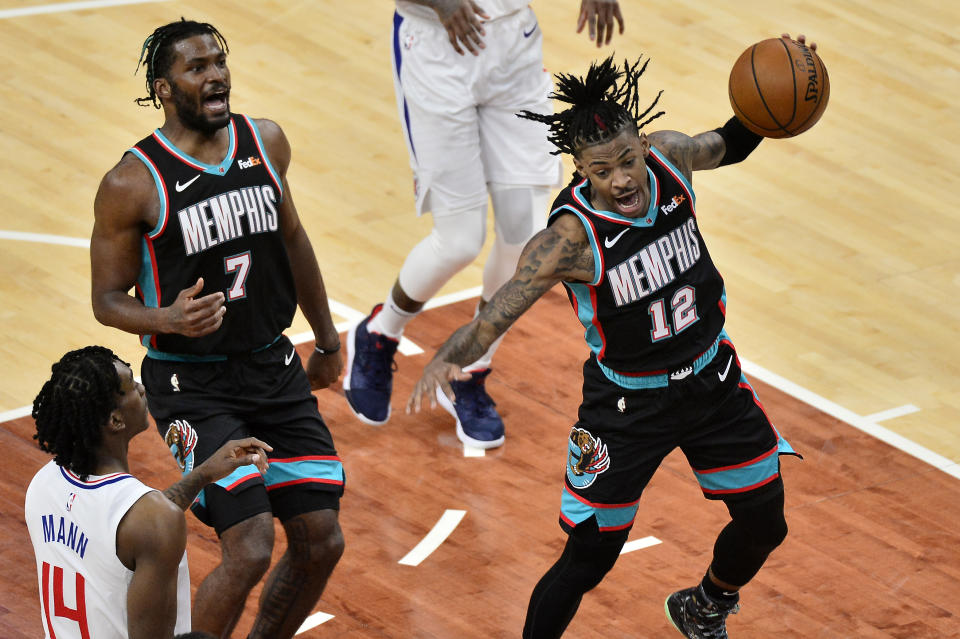 Memphis Grizzlies guard Ja Morant (12) handles the ball after a dunk in the first half of an NBA basketball game against the Los Angeles Clippers Thursday, Feb. 25, 2021, in Memphis, Tenn. (AP Photo/Brandon Dill)