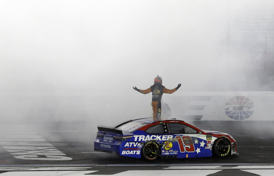 Martin Truex Jr. celebrates after winning the NASCAR Cup Series auto race at Charlotte Motor Speedway in Concord, N.C., Sunday, May 26, 2019. (AP Photo/Chuck Burton)