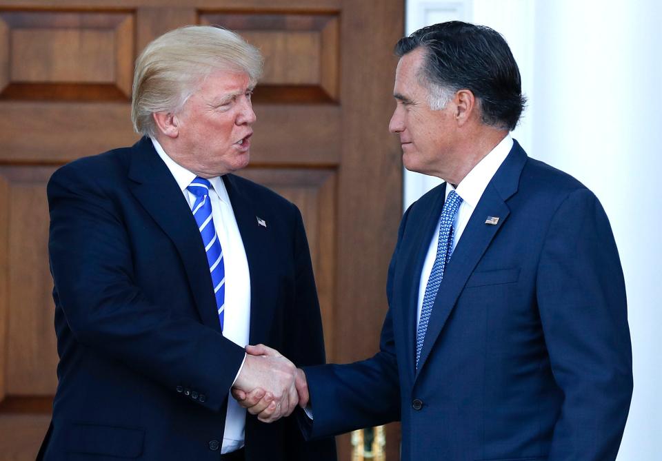 In November 2016, President-elect Donald Trump and Mitt Romney shake hands as Romney leaves the Trump National Golf Club Bedminster in Bedminster, N.J.   