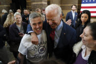 Democratic presidential candidate former Vice President Joe Biden laughs with Jeno Berta, of Bettendorf, Iowa, left, during a community event, Wednesday, Oct. 16, 2019, in Davenport, Iowa. (AP Photo/Charlie Neibergall)