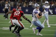 Dallas Cowboys tight end Dalton Schultz (86) catches a pass as Tampa Bay Buccaneers safety Mike Edwards (32) and Antoine Winfield Jr. (31) defend in the second half of a NFL football game in Arlington, Texas, Sunday, Sept. 11, 2022. (AP Photo/Michael Ainsworth)