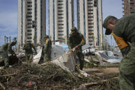 Soldiers gather debris in the aftermath of Hurricane Otis ,in Acapulco, Mexico, Saturday, Oct. 28, 2023. (AP Photo/Felix Marquez)