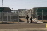 Border Patrol agents wait to reporters an immigration holding facility, Tuesday, Feb. 25, 2020, in El Paso, Texas. The complex of modular buildings can house and process 1,040 and will replace tents hastily erected for processing last spring. (AP Photo/Cedar Attanasio)