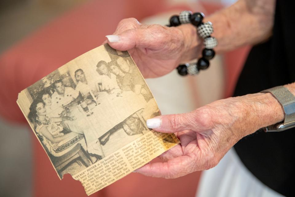 Ardith Marguleas holds a newspaper clipping from the early days of her and her husband's social life in Rancho Mirage.