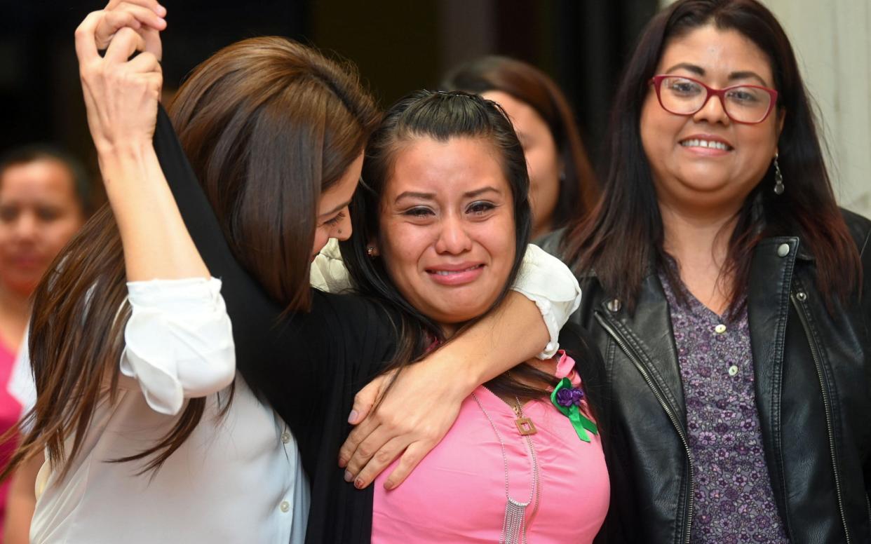 Evelyn Hernandez (C) celebrates with her lawyers after being cleared of murder - AFP
