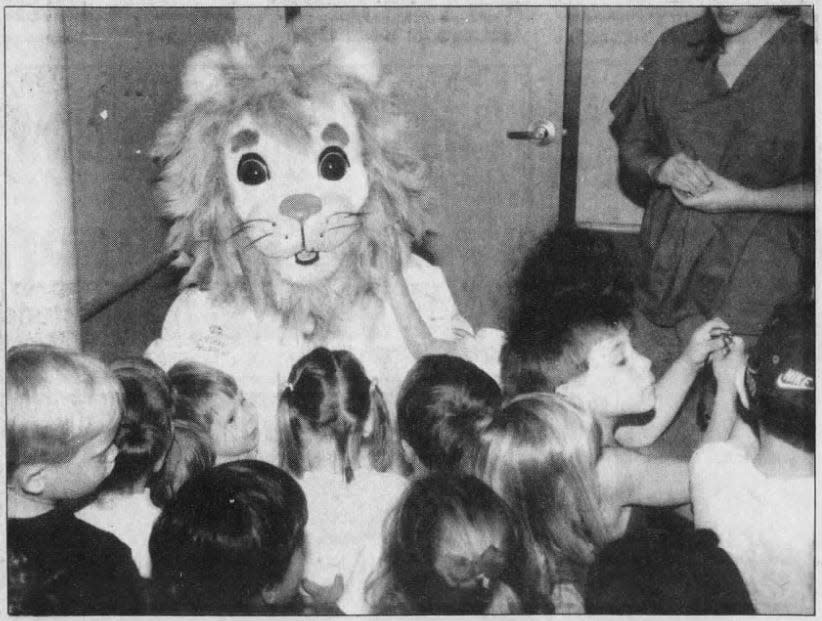 In this 1998 file photo, Aurora Health Care mascot Dr. A-Roar-A welcomes children to the new clinic on Wisconsin American Drive.