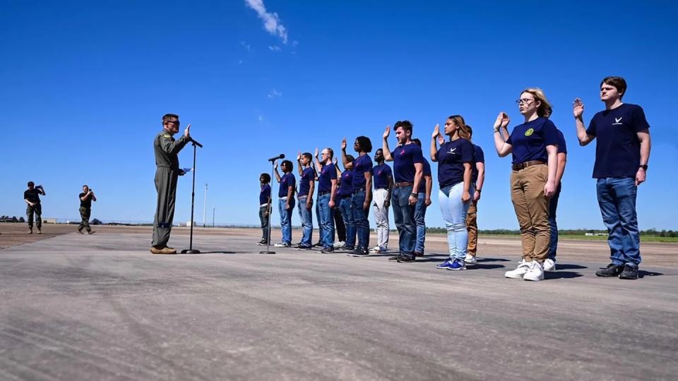 Air Force Col. Scott Weyermuller swears in new Air Force recruits at Barksdale Air Force Base, La., on March 25. (Airman 1st Class William Pugh/Air Force)