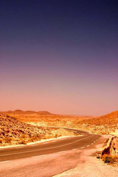 A desert road by night in the Atlas Mountains - Credit: AP
